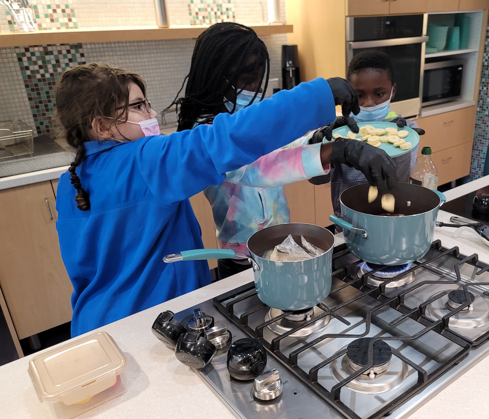 kids cooking in teaching kitchen