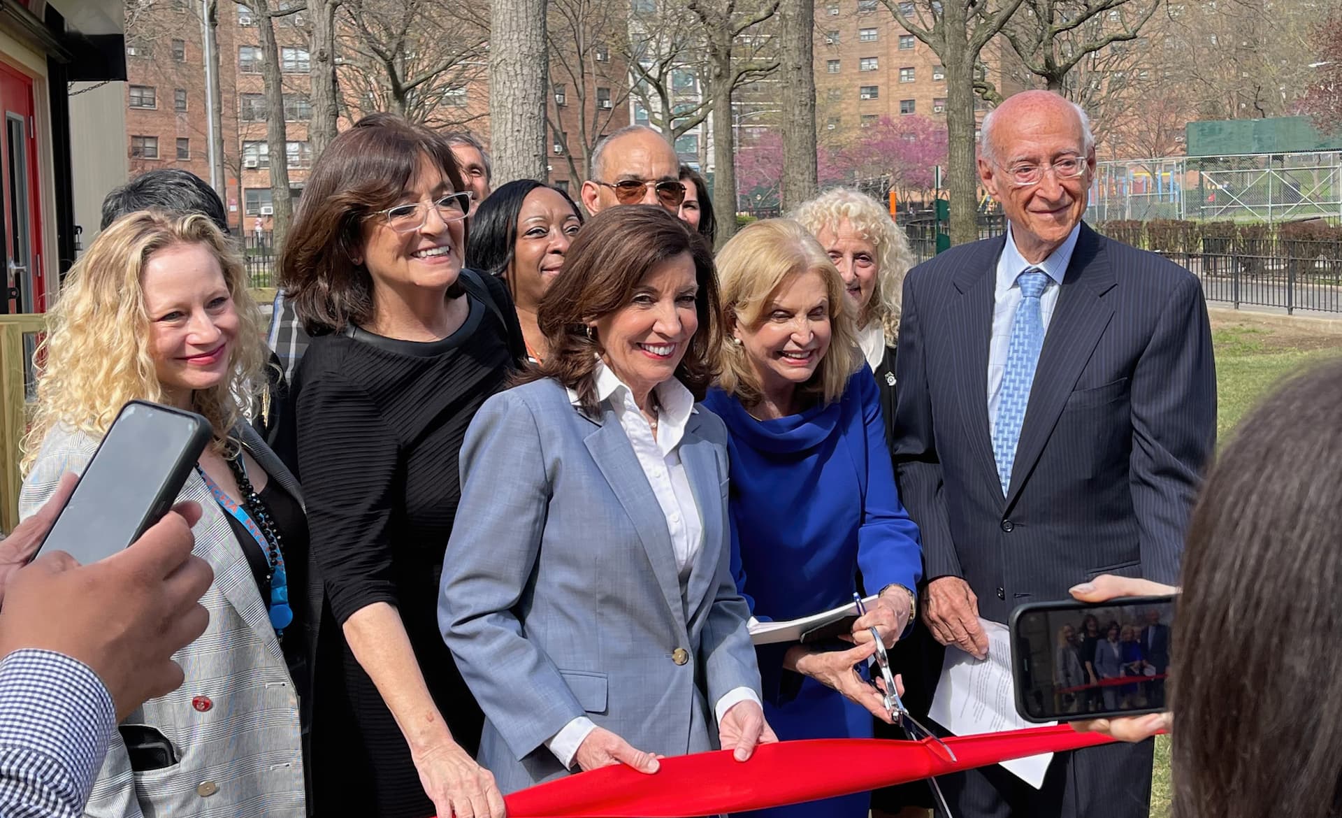 gov. hochul and rep. maloney cutting the ribbon to astoria houses covid center