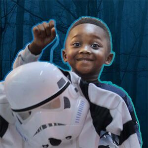 Kid holding up stormtrooper costume