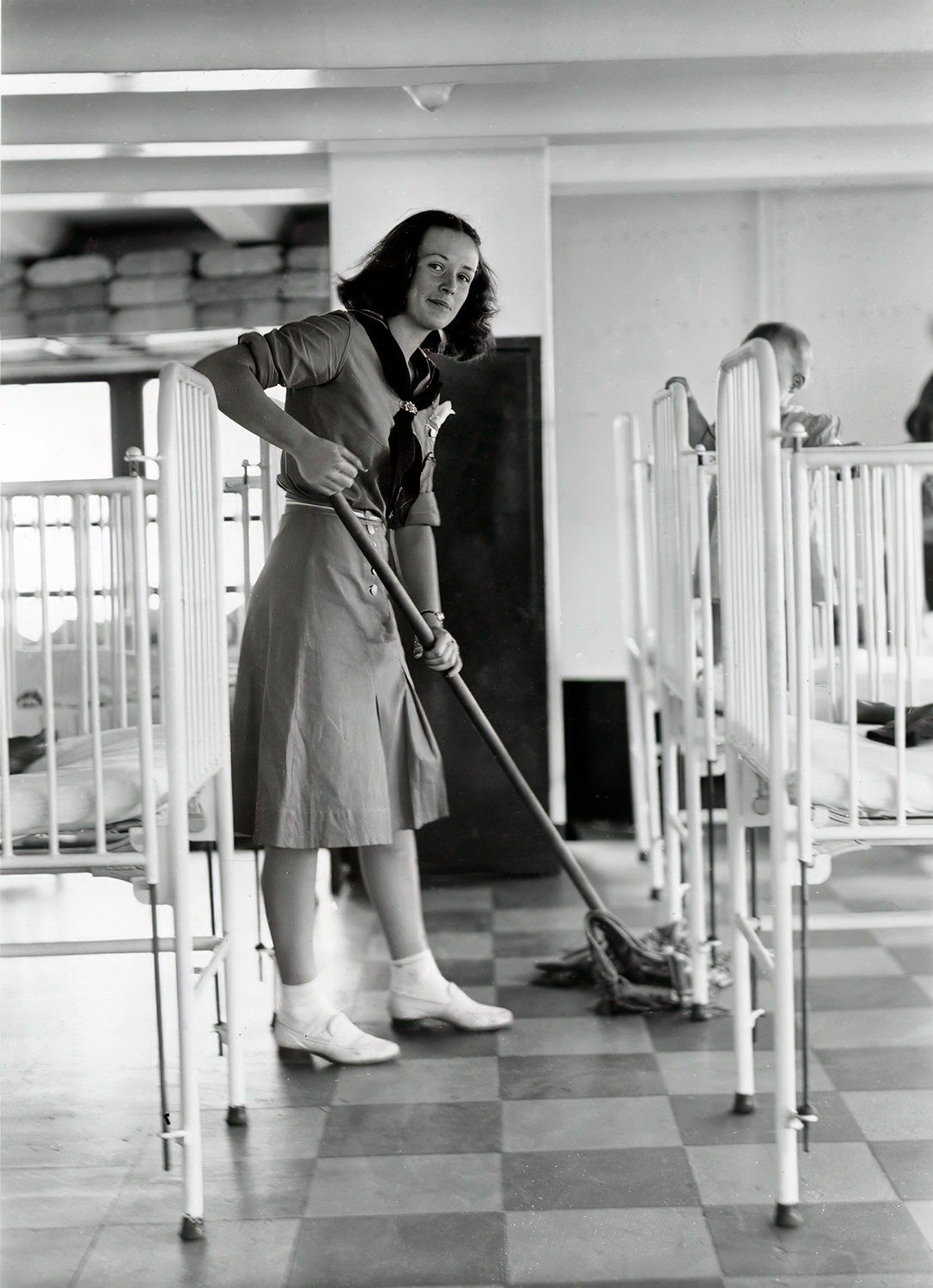 Mariner Girl Scout sweeps the nursery floor