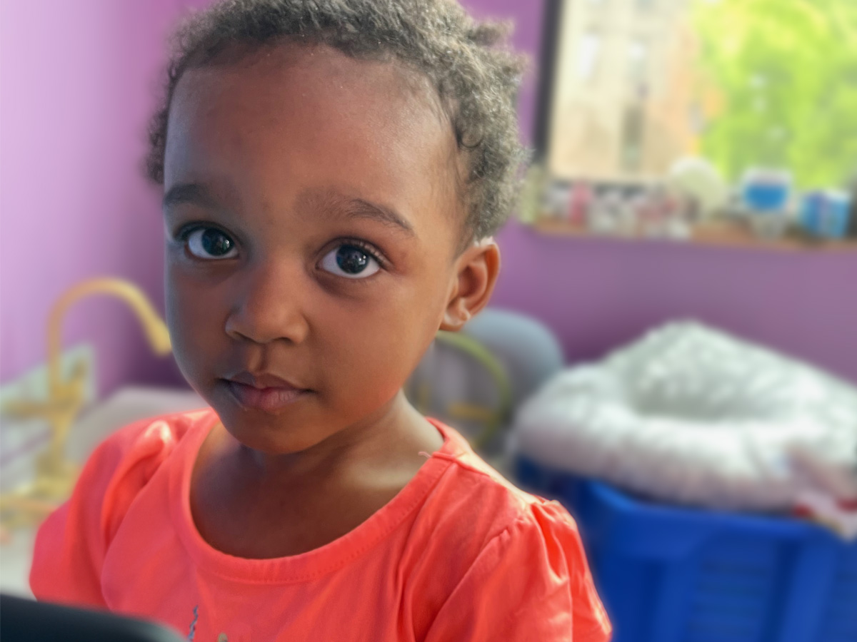Young girl with short hair and big eyes stares at the camera